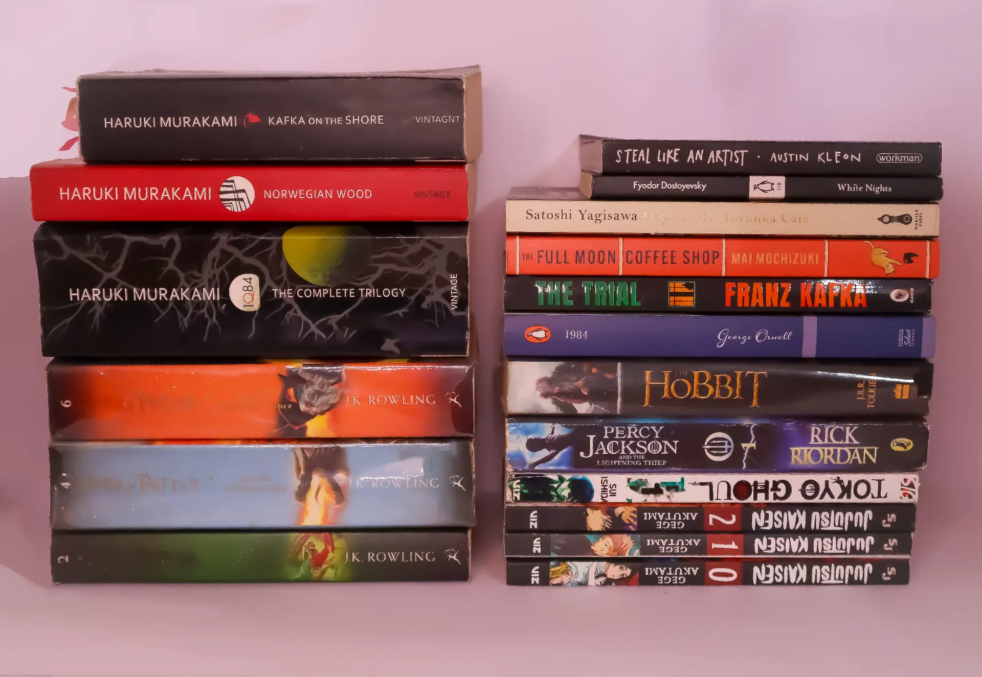 Two stacks of novels and manga including Murakami, Kafka and Tolkien